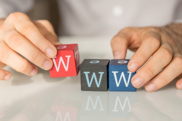 justhost web hosting service review hands holding colored cubes with w letter on them www